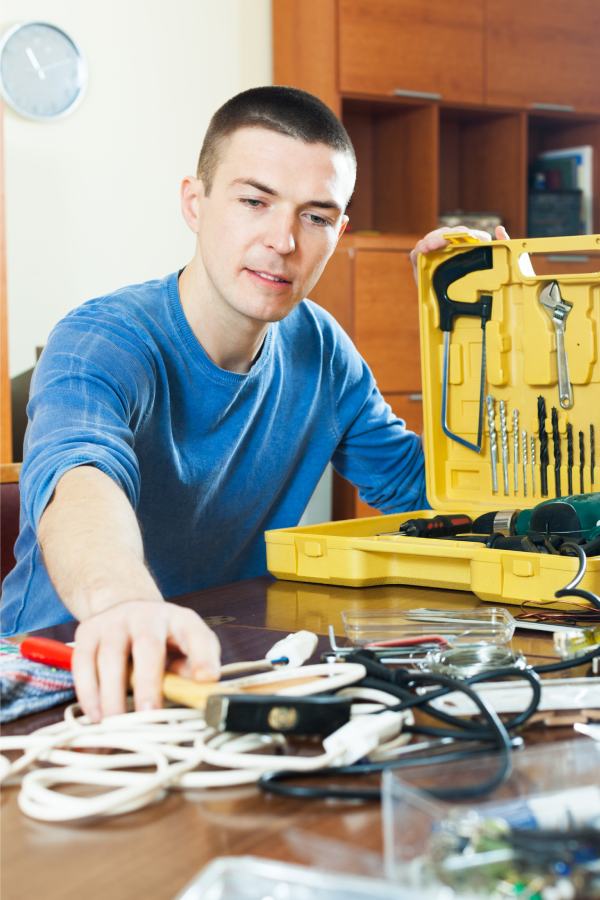 handsome-man-with-toolbox-reaching-hammer